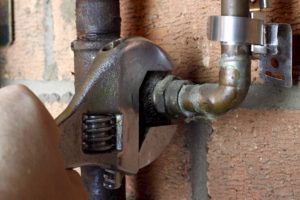 close up of plumber working on a gas pipe