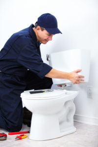 professional plumber doing toilet repair