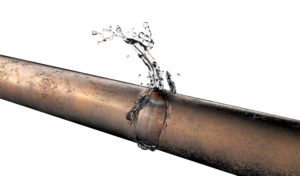 a close up of a plumbing pipe with a leak