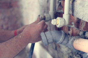 Plumber performing leak detection