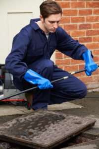 man performing a sewer cleaning