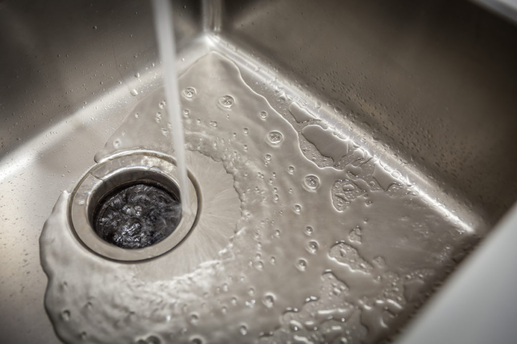 Stainless kitchen sink with food waste disposal